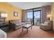 Welcoming living room area with a cozy sofa, chair, coffee table, and balcony access offering beautiful ocean views at 1501 S Ocean Blvd. # 1231, Myrtle Beach, SC 29577