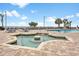 Outdoor pool area featuring a jetted hot tub, lounge chairs, and palm trees at 1501 S Ocean Blvd. # 1231, Myrtle Beach, SC 29577