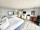 Inviting bedroom featuring a queen bed, modern amenities, and wood-look floors at 1905 S Ocean Blvd. # 922-924, Myrtle Beach, SC 29577