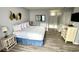 Bright bedroom featuring a queen bed, modern decor, and wood-look floors at 1905 S Ocean Blvd. # 922-924, Myrtle Beach, SC 29577