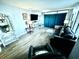Bright living room with stylish furniture, a flat-screen TV, and sleek laminate flooring at 1905 S Ocean Blvd. # 922-924, Myrtle Beach, SC 29577