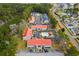 Aerial view of a community with vibrant red roofs, a pool, and lush greenery at 193 Charter Dr. # E7, Longs, SC 29568
