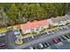 Aerial view of a condo complex with ample parking, mature trees, and well-maintained landscaping at 193 Charter Dr. # E7, Longs, SC 29568