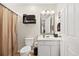 Clean bathroom featuring a vanity with sink, toilet, and wood look flooring at 193 Charter Dr. # E7, Longs, SC 29568