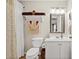 Clean bathroom with white vanity, mirrored medicine cabinet, and shower with patterned curtain at 193 Charter Dr. # E7, Longs, SC 29568