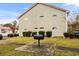 A tan building exterior with white trim, a grill on a concrete pad and manicured landscaping at 193 Charter Dr. # E7, Longs, SC 29568