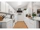 Well-lit kitchen featuring white cabinets, modern appliances, and wood-look flooring at 193 Charter Dr. # E7, Longs, SC 29568