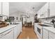 Open kitchen featuring white cabinets and modern appliances, seamlessly connected to the dining area at 193 Charter Dr. # E7, Longs, SC 29568