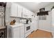 Bright kitchen with white appliances, ample counter space, and wood-look flooring at 193 Charter Dr. # E7, Longs, SC 29568