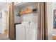 Laundry closet with a side by side washer and dryer and white wire shelf for storage at 193 Charter Dr. # E7, Longs, SC 29568