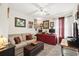 Cozy living room with neutral colors, ceiling fan, plush seating, and an accenting dark red desk area at 193 Charter Dr. # E7, Longs, SC 29568
