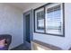 Cozy balcony with a window, textured wall, and a comfortable chair for relaxation at 2001 S Ocean Blvd. # 914, Myrtle Beach, SC 29577