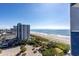 Beach view from balcony showing beach access and parking at 2001 S Ocean Blvd. # 914, Myrtle Beach, SC 29577