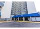 Exterior building entrance features a blue awning, well-maintained facade, and loading zone at 2001 S Ocean Blvd. # 914, Myrtle Beach, SC 29577