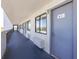 Well-lit hallway with multiple unit entrances and large windows offering a view of the outdoors at 2001 S Ocean Blvd. # 914, Myrtle Beach, SC 29577