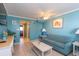 Inviting living room with a plush sofa, tile floors, and turquoise walls at 2001 S Ocean Blvd. # 914, Myrtle Beach, SC 29577