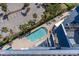 Overhead view of the pool area with palm trees and parking lot in background at 2001 S Ocean Blvd. # 914, Myrtle Beach, SC 29577