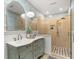 Stylish bathroom with dual sinks, decorative wallpaper, and a tiled shower with glass doors at 2170 Deerfield Ave., Surfside Beach, SC 29575