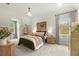 Bright bedroom with a hanging chair, large windows, and neutral decor at 2170 Deerfield Ave., Surfside Beach, SC 29575