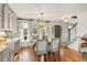 Bright dining area with stylish curtains, decorative mirrors, and an adjacent staircase at 2170 Deerfield Ave., Surfside Beach, SC 29575