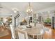Open-concept dining area featuring hardwood floors, decorative light fixtures, and access to kitchen and living areas at 2170 Deerfield Ave., Surfside Beach, SC 29575