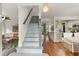 Inviting foyer with light-blue stairs, hardwood floors, and elegant lighting leading to the living spaces at 2170 Deerfield Ave., Surfside Beach, SC 29575