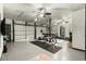 Spacious garage featuring three overhead doors, fitness equipment, overhead lighting, and epoxy floors at 2170 Deerfield Ave., Surfside Beach, SC 29575