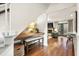 Hallway space with desk under stairs that leads into a living room with fireplace and French doors at 2170 Deerfield Ave., Surfside Beach, SC 29575