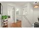 Bright hallway with hardwood floors leads to the bedroom, complemented by white wainscoting and natural light at 2170 Deerfield Ave., Surfside Beach, SC 29575