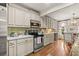 Well-lit kitchen with stainless steel appliances, marble countertops, and backsplash with earth-toned ceramic tiles at 2170 Deerfield Ave., Surfside Beach, SC 29575