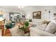 Bright living room with modern lighting, hardwood floors, and an open layout to the kitchen and dining spaces at 2170 Deerfield Ave., Surfside Beach, SC 29575
