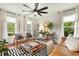 Cozy living room featuring leather sofa, neutral chairs, natural light, wooden floors, and decorative accents at 2170 Deerfield Ave., Surfside Beach, SC 29575