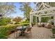 Outdoor patio seating area with dining table, pergola, landscaping, and a view of the water at 2170 Deerfield Ave., Surfside Beach, SC 29575