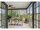Screened-in porch with views of landscaped backyard featuring woven furniture, ceiling fan, and a statue at 2170 Deerfield Ave., Surfside Beach, SC 29575