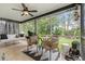 Screened-in porch with views of landscaped backyard featuring woven furniture, ceiling fan, and a statue at 2170 Deerfield Ave., Surfside Beach, SC 29575