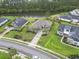 Aerial view of a beautifully landscaped home, showcasing its lakefront setting and lush green surroundings at 2204 Woodstork Dr., Conway, SC 29526