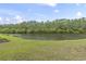 The backyard borders a pond that is surrounded by trees at 2204 Woodstork Dr., Conway, SC 29526