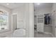 A modern bathroom featuring a standalone tub, marble floors, and a walk-in closet at 2204 Woodstork Dr., Conway, SC 29526