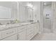 Beautiful bathroom features double vanity with marble countertops and a tiled shower with glass door at 2204 Woodstork Dr., Conway, SC 29526