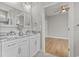Bright bathroom with double vanity, white cabinets, and granite countertop, with a view into the bedroom at 2204 Woodstork Dr., Conway, SC 29526