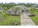 Beautiful one-story home with a well-manicured lawn, palm trees, and a spacious driveway at 2204 Woodstork Dr., Conway, SC 29526