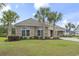 Home exterior with palm trees, a well-kept lawn, brick facade, and manicured shrubbery at 2204 Woodstork Dr., Conway, SC 29526