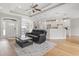 Open-concept living space with hardwood floors, a kitchen island, and modern lighting fixtures at 2204 Woodstork Dr., Conway, SC 29526