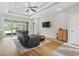 Cozy living room with a tray ceiling, hardwood floors, a ceiling fan, and sliding glass doors at 2204 Woodstork Dr., Conway, SC 29526