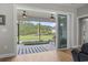 The covered patio has a ceiling fan, a striped rug, and overlooks the landscaped backyard at 2204 Woodstork Dr., Conway, SC 29526