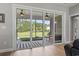 The covered patio has a ceiling fan, a striped rug, and overlooks the landscaped backyard at 2204 Woodstork Dr., Conway, SC 29526