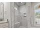 Luxurious walk-in shower with marble tile, built-in bench, and a rainfall shower head at 2204 Woodstork Dr., Conway, SC 29526