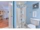 Bright blue bathroom with a walk in shower with white tiled floors and a toilet at 223 Maisons Dr. # C8, Myrtle Beach, SC 29572