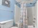 Bathroom features a shower/tub combo with a charming ocean-themed shower curtain and a blue painted wall at 223 Maisons Dr. # C8, Myrtle Beach, SC 29572