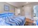 Comfortable bedroom with blue and white striped bedding and a closet for storage at 223 Maisons Dr. # C8, Myrtle Beach, SC 29572